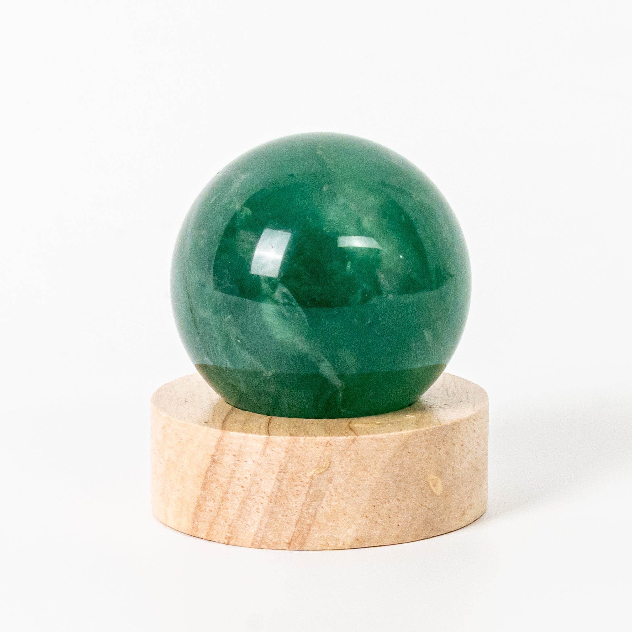 Green Fluorite Sphere with LED Base 6cm, ideal for refreshing home spaces with vibrant green tones.