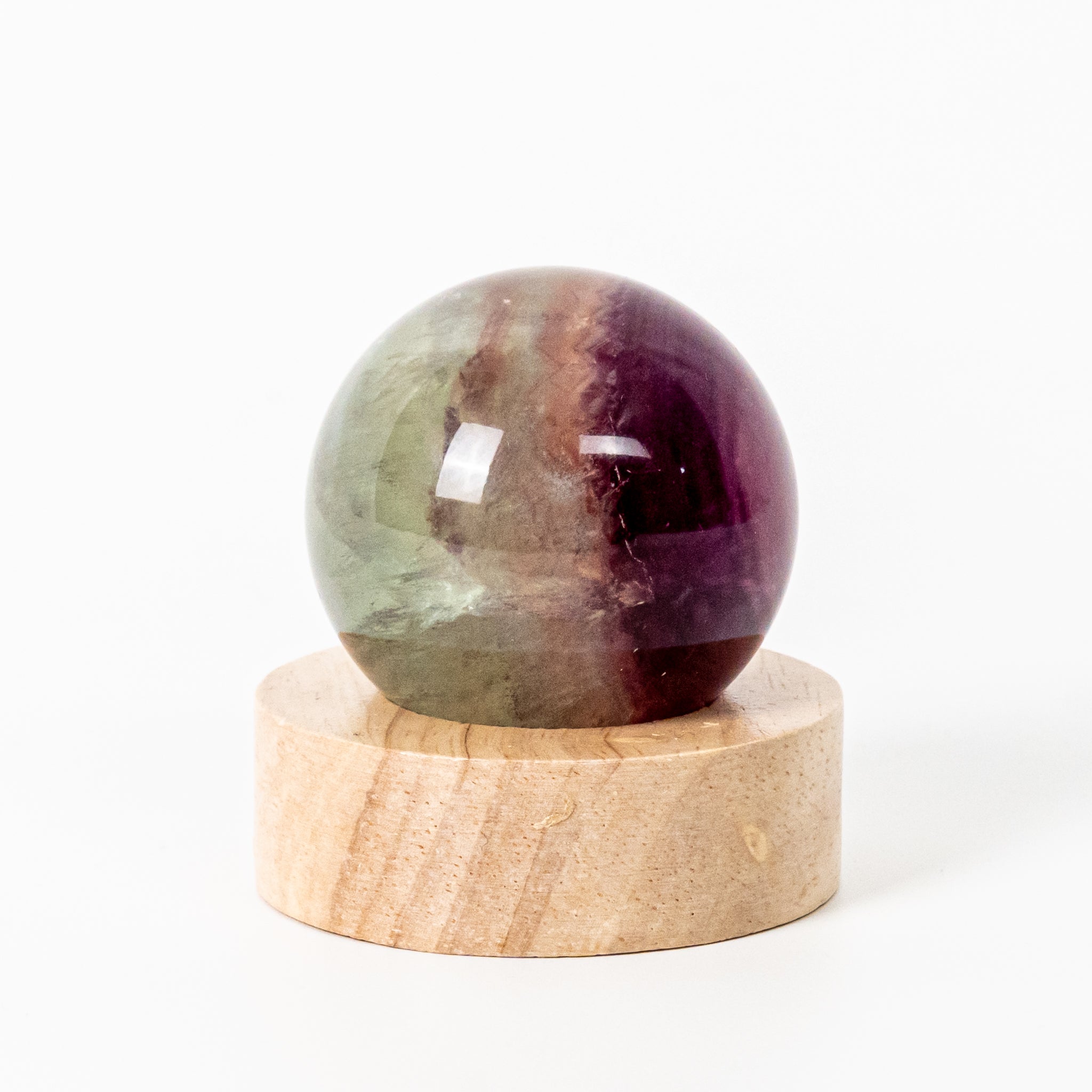 Rainbow Fluorite Sphere with LED Base 6cm, featuring green, purple, and blue bands for vibrant decor.