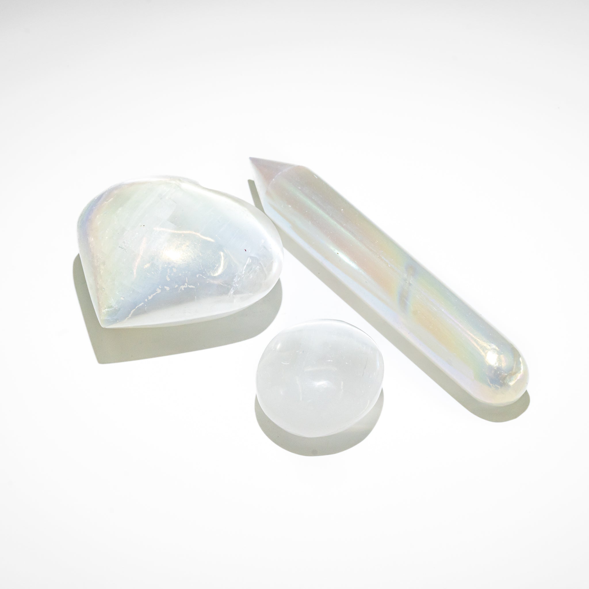 Selenite Purification Set with Wand, Heart, Round Stone, and Tower for energy cleansing in homes.