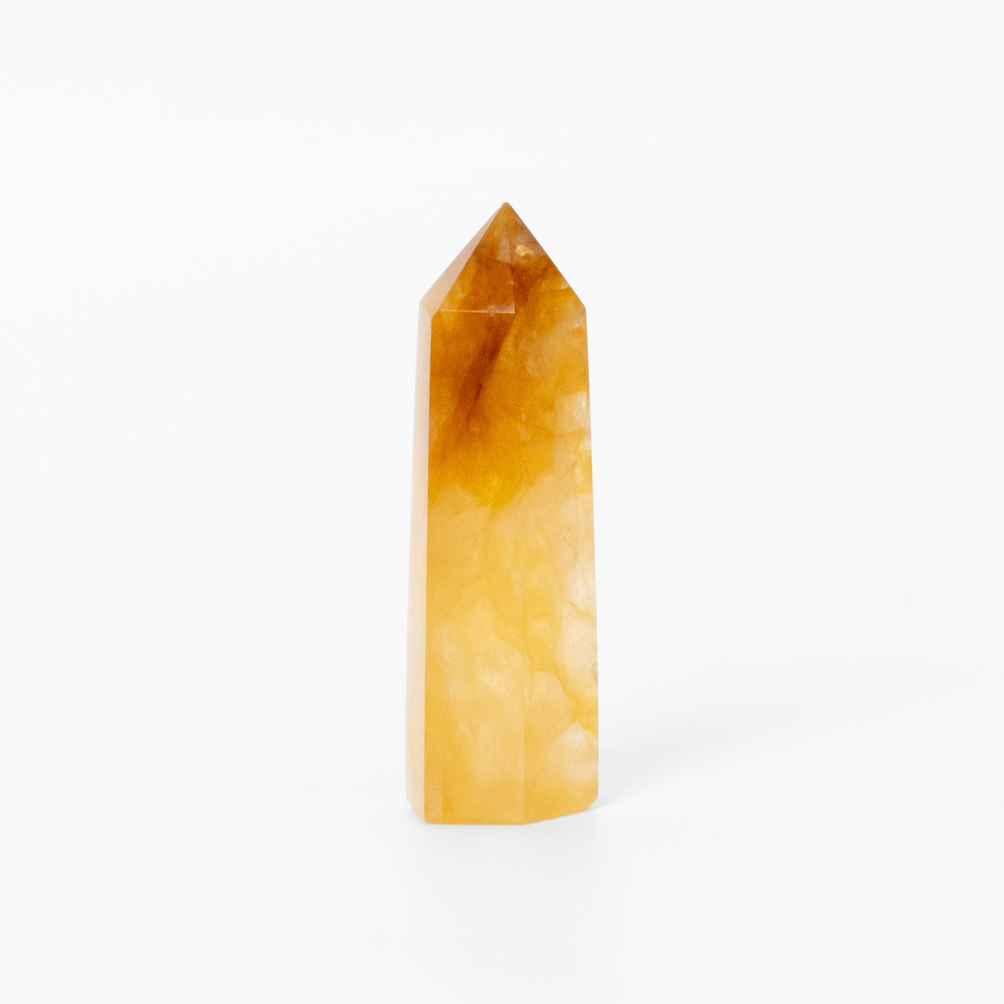 Yellow Calcite Obelisk ornament with bright yellow tones, promoting positivity in home decor.